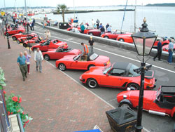 Red cars on the quay