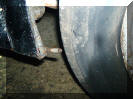 Securing lug for wheel spat cover - one either side of the rear wheel
