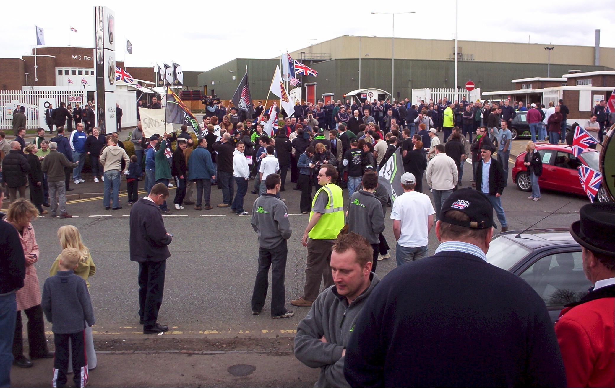 Workers join the rally supporters out side Q gate.